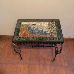 Wrought Iron table with porcelain top with sailboat.